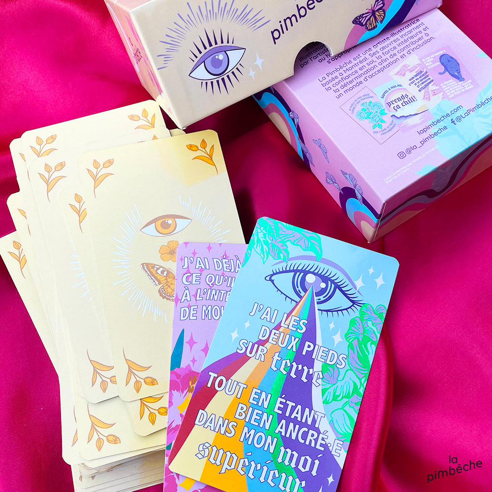 Pack of Badass Manifestor oracle cards. The 62 cards of the pack are shown. It is set on a pink background.